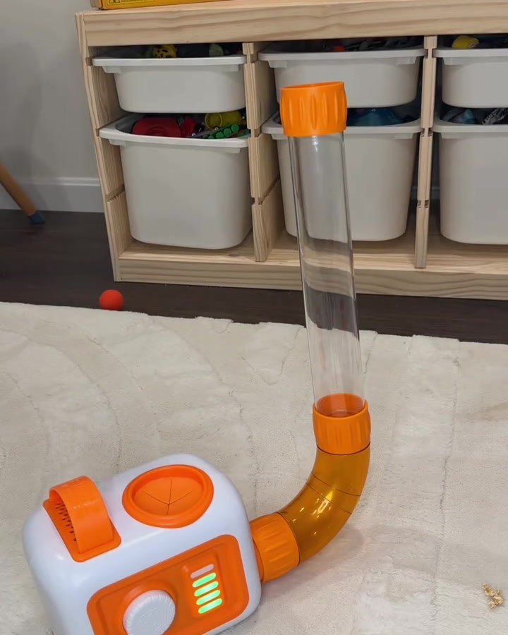 Foam balls shooting out of the top of a vertical tube