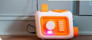 The EVO fan unit charging from a wall outlet