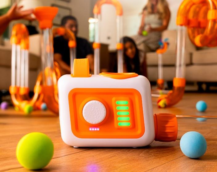 EVO fan unit on a wood floor with foam balls